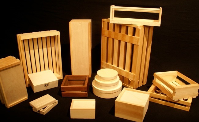 Assorted custom wooden boxes and crates, including slatted crates, hinged boxes, and slide-top designs for storage and packaging.